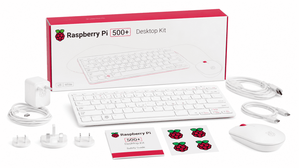 Raspberry Pi 500+ Desktop Kit white keyboard mouse power adapter cables and setup guides beside the box
